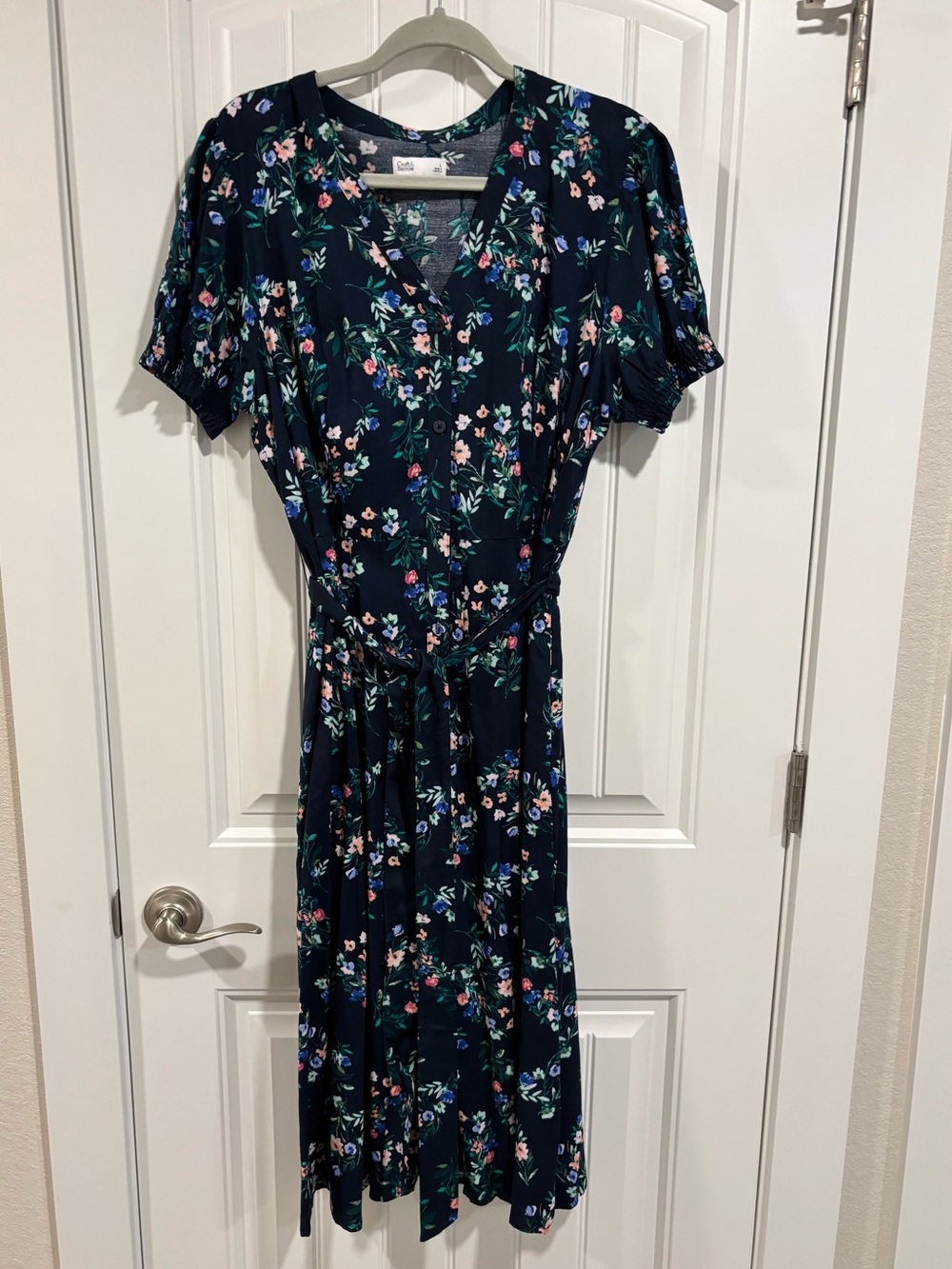 navy dress with floral print
Size Large